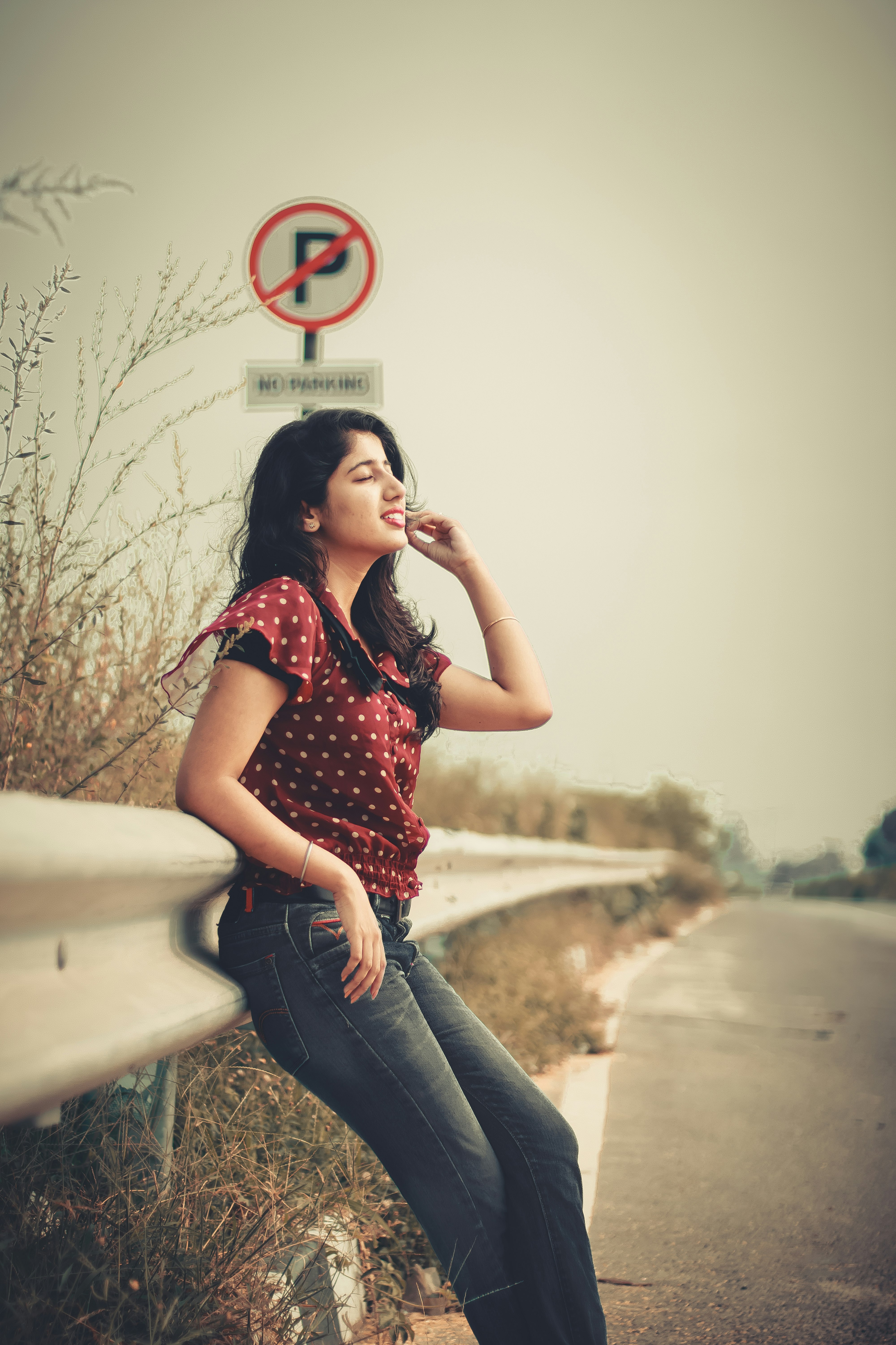 woman leaning on gray metal railings